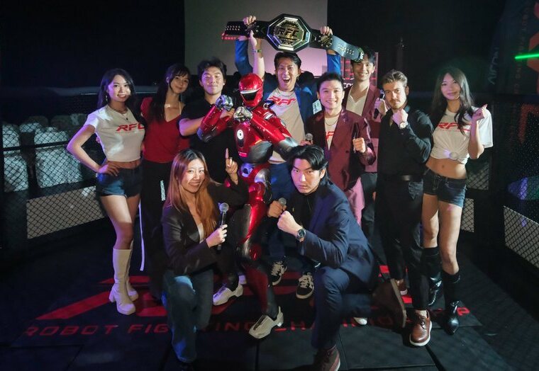 The RFC team and crew in the cage holding the championship belt