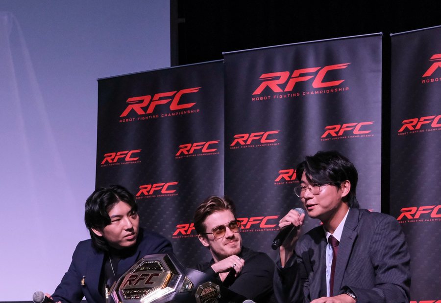 RFC press conference with the championship belt on the table